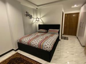 a bedroom with a large bed in a room at The Family Den in Rawalpindi