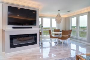 a living room with a fireplace and a table with chairs at 2105 Bay Pointe Villa in Seabrook Island