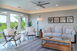 a living room with a couch and chairs and a table at 2105 Bay Pointe Villa in Seabrook Island