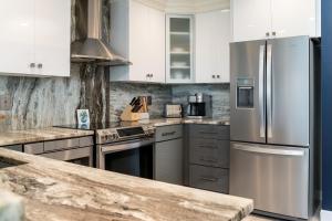 a kitchen with white cabinets and stainless steel appliances at 2105 Bay Pointe Villa in Seabrook Island