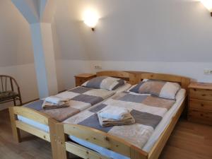 a bedroom with two beds with towels on them at Pension Markt Neustrelitz in Neustrelitz