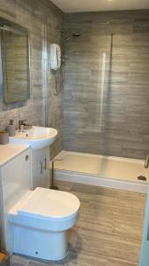 a bathroom with a toilet and a sink and a shower at Church inn en-suite rooms with Wi-Fi in Moorside