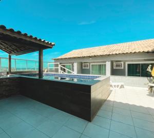 a swimming pool in the backyard of a house at Pousada São Pedro in São Pedro da Aldeia +54 photos