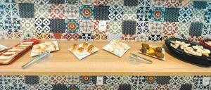 a table with different types of food on it at Pousada São Pedro in São Pedro da Aldeia