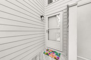 a colorful umbrella sitting on a porch next to a window at 1235 Creekwatch Villa in Seabrook Island