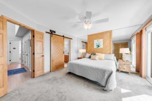 a bedroom with a bed and a ceiling fan at 1235 Creekwatch Villa in Seabrook Island
