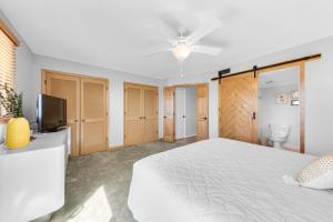 a bedroom with a white bed and a television at 1235 Creekwatch Villa in Seabrook Island +24 photos
