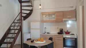 una pequeña cocina con una mesa y una escalera de caracol en Rodea Sunrise en Rodhiá