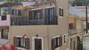 Rodhiá的住宿－Rodea Sunrise，带阳台和遮阳伞的建筑