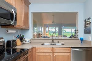 a kitchen with a sink and a microwave at 1211 Creekwatch Villa in Seabrook Island