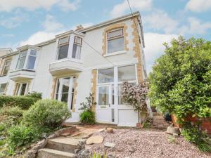 a white house with a white door at 18 Ffordd Tanrallt in Prestatyn