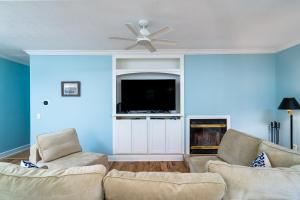 a living room with two couches and a flat screen tv at 2504 Chateau by the Green in Seabrook Island