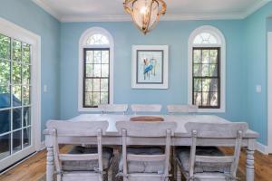 a dining room with blue walls and a table with chairs at 2504 Chateau by the Green in Seabrook Island