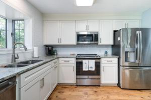 a kitchen with white cabinets and a stainless steel refrigerator at 2504 Chateau by the Green in Seabrook Island +19 photos