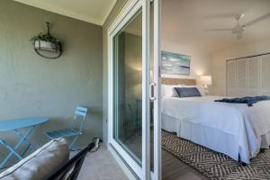 a bedroom with a bed and a sliding glass door at 2123 Bay Pointe Villa in Seabrook Island +32 photos