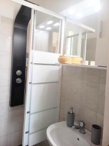 a bathroom with a sink and a mirror at M.V.G.M.-Home in Ios Chora