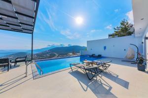 a house with a swimming pool and a patio at Villa Arya in Kaş