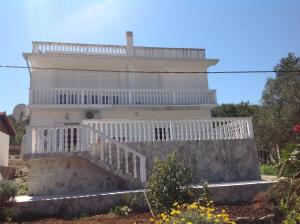 a white house with stairs in front of it at Guest House "Paradise" in Tivat