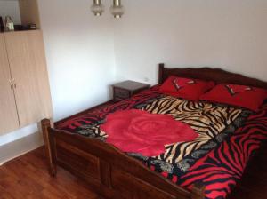 a bedroom with a bed with a zebra print blanket at Guest House "Paradise" in Tivat