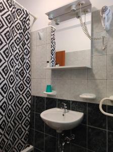 a bathroom with a sink and a mirror at Rooms Carija in Trogir