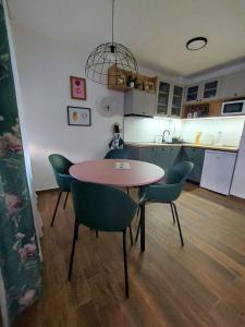 a kitchen and dining room with a table and chairs at Home Apartment LUNA in Skopje