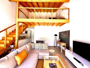 a living room with a couch and a loft at Quinta das Carpas in Tavira