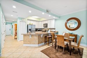 a kitchen and dining room with a table and chairs at San Carlos #407 in Gulf Shores