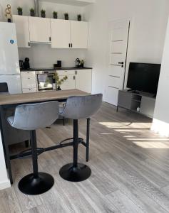 a kitchen with a desk and a chair in a room at Studio46 in Klaipėda