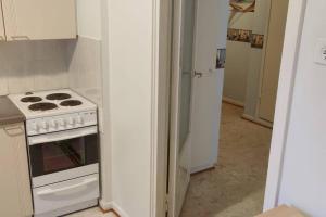 a kitchen with a white stove and a refrigerator at Cozy easy-to-stay 2room apartment 1km from Rauma centre in Rauma +7 photos
