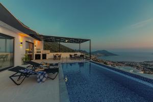a house with a swimming pool with a view of the ocean at Villa Arya in Kaş