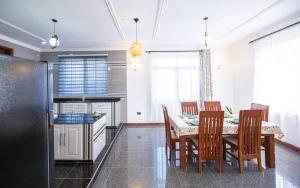 a kitchen and dining room with a table and chairs at Lerailuxuryhomes 