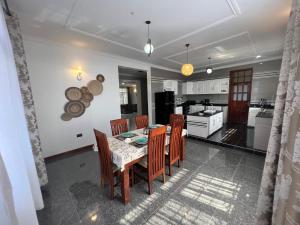 a kitchen and dining room with a table and chairs at Lerailuxuryhomes 