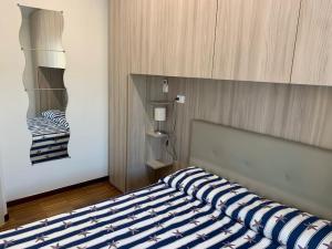 a bedroom with a bed with a blue and white blanket at Gassa d'Amante Appartamento in Rapallo