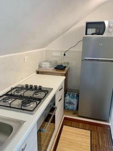a kitchen with a stove and a refrigerator at Gassa d'Amante Appartamento in Rapallo