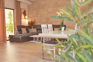 a living room with a couch and a table and chairs at Villa Ilijana in Tivat