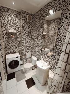 a bathroom with a toilet and a sink at Centrally located Studio apartment in Rīga