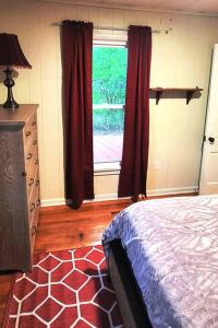a bedroom with a bed and a window at FLX 1890's Farmhouse in Hector