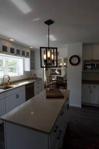 a kitchen with a large island in the middle at FLX 1890's Farmhouse in Hector