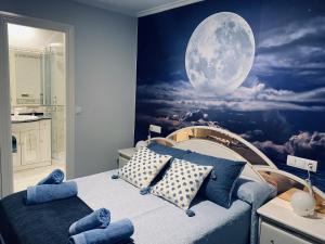 a bedroom with a moon mural on the wall at Luna Llena (Soria) in Soria