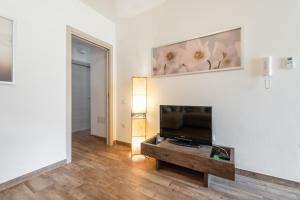 a living room with a flat screen tv on a wall at La Casa di Francy in Villasimius