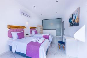 a bedroom with two beds and a large mirror at Villa Arya in Kas