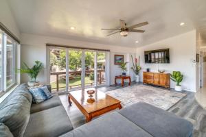 a living room with a couch and a table at Updated Poipu Home Large Deck with Scenic View in Koloa