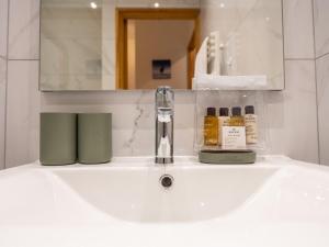 a bathroom sink with a soap dispenser on it at Appartement Huez, 2 pièces, 5 personnes - FR-1-645-17 in LʼHuez