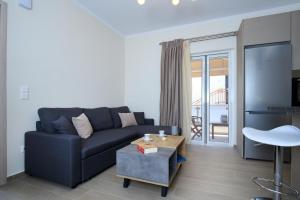 a living room with a couch and a table at Kallithea Guesthouse in Nydri