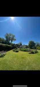 a park with a bench in a field of grass at Broadmoor Farm in Kilgetty +9 photos