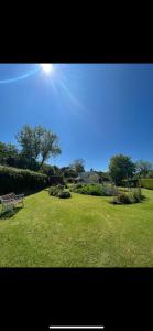 a park with a bench in a field of grass at Broadmoor Farm in Kilgetty