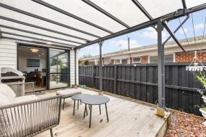 a pergola on the deck of a house at Modern 5BR in Mangere - 6 mins from the Airport in Auckland