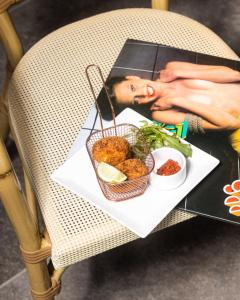 a woman laying on a table with a plate of food at Hotel River fronte mare con piscina in Rimini