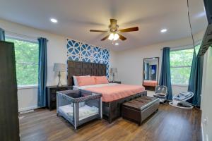 a bedroom with a bed and a ceiling fan at Poconos Family Getaway with Fire Pit and 2 Game Rooms in Pocono Summit