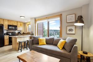 a living room with a couch and a kitchen at Studio @ The Village w/Incredible Views~Sleeps 4 in Breckenridge